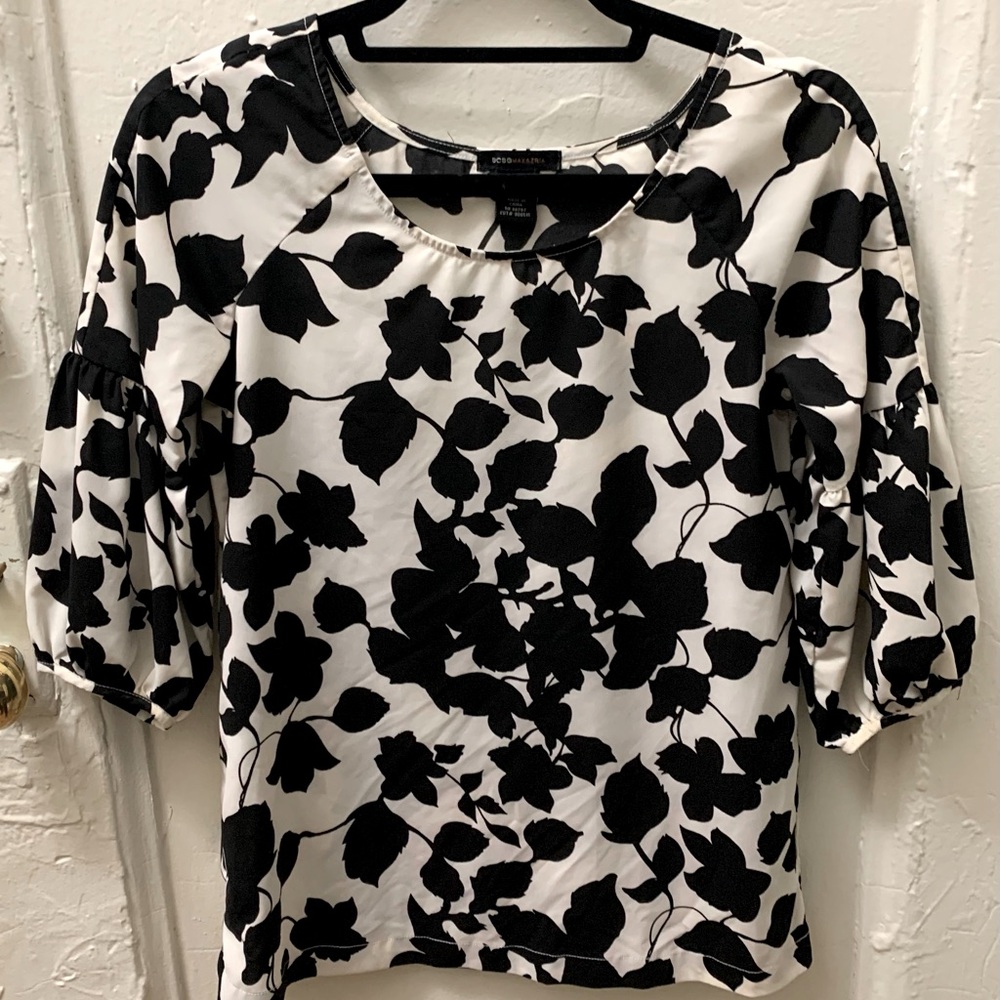 BCBG black and white floral blouse with puffy sleeves.